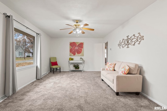 living area with carpet flooring and ceiling fan