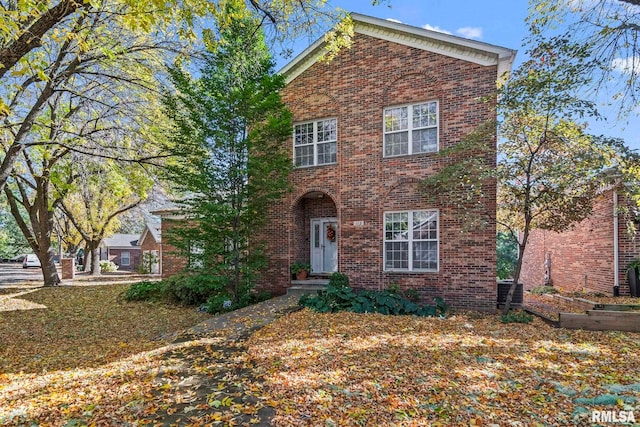 front of property featuring a front lawn and cooling unit