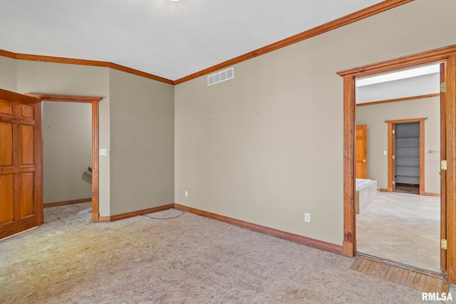 carpeted spare room with crown molding