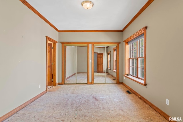 unfurnished room with crown molding