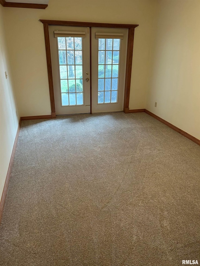 spare room with french doors and carpet flooring