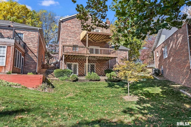 back of property featuring a wooden deck and a yard