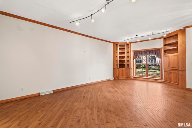 unfurnished living room featuring light hardwood / wood-style floors and ornamental molding