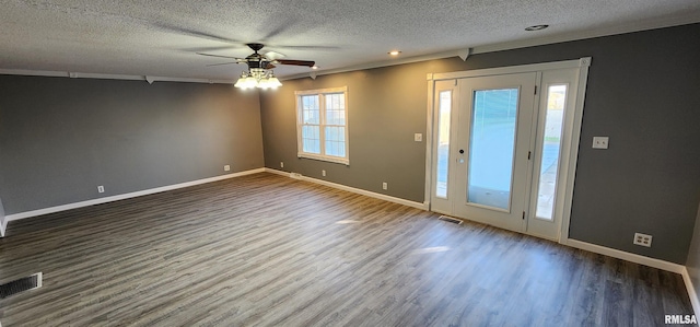 empty room with dark wood-type flooring, a textured ceiling, ceiling fan, and crown molding