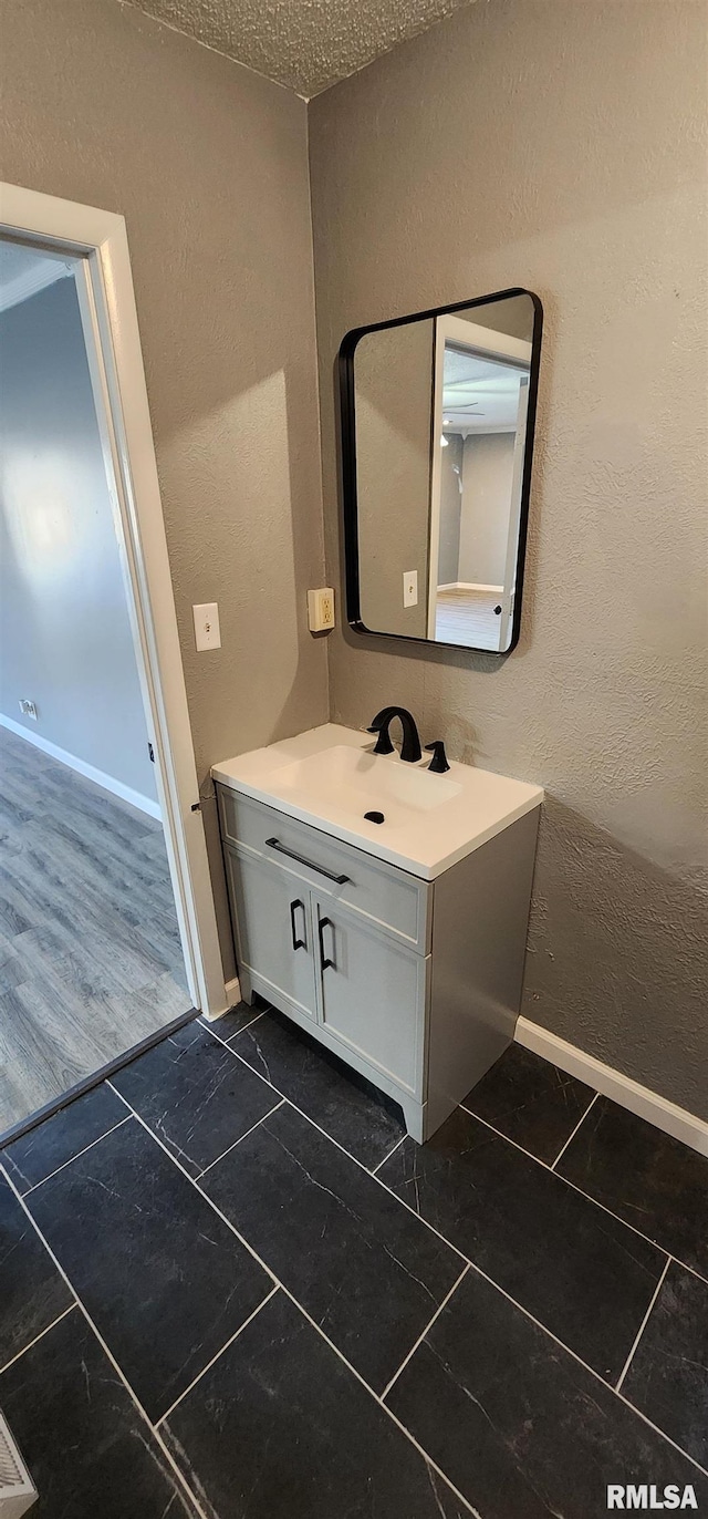 bathroom with vanity and a textured ceiling