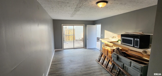 interior space with wood-type flooring and a textured ceiling