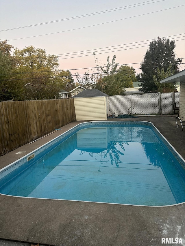 pool at dusk with a shed