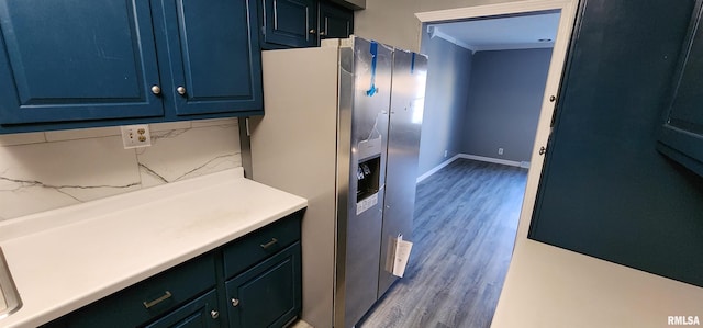 kitchen featuring stainless steel fridge with ice dispenser, light wood-type flooring, blue cabinets, and backsplash