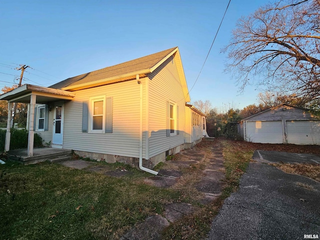 view of front of home featuring a garage and an outdoor structure