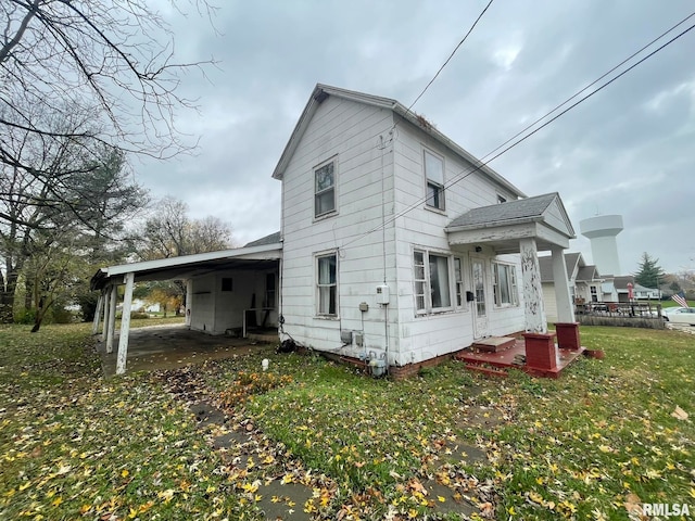 view of home's exterior featuring a yard and a carport