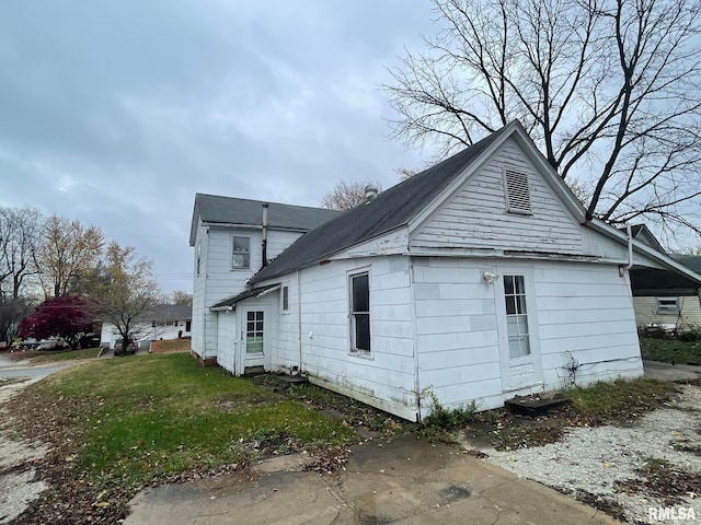 view of property exterior featuring a lawn