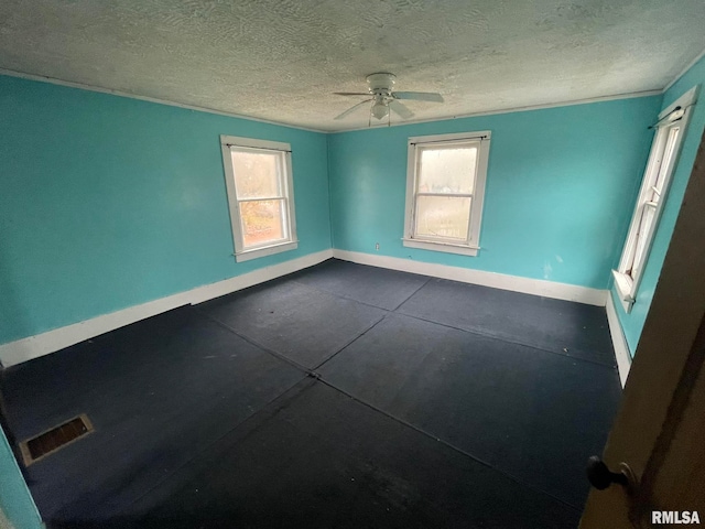 spare room featuring ceiling fan and a textured ceiling