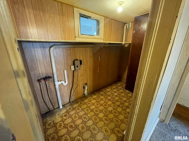 washroom featuring wooden walls