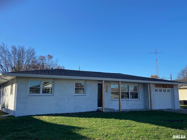 single story home featuring a garage and a front lawn