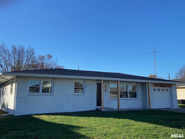 716 W Pauline St, Taylorville, IL 62568 - single story home featuring brick siding, a front lawn, and an attached garage