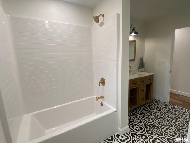716 W Pauline St, Taylorville, IL 62568 - bathroom with washtub / shower combination, vanity, and baseboards