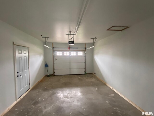 716 W Pauline St, Taylorville, IL 62568 - garage featuring a garage door opener and baseboards
