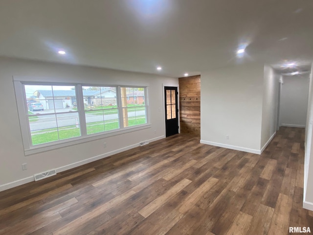 empty room with dark hardwood / wood-style flooring