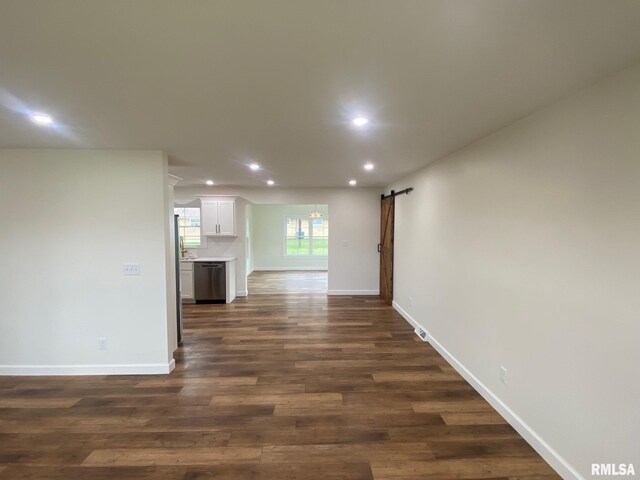 716 W Pauline St, Taylorville, IL 62568 - unfurnished living room featuring a barn door, recessed lighting, dark wood-style floors, and baseboards