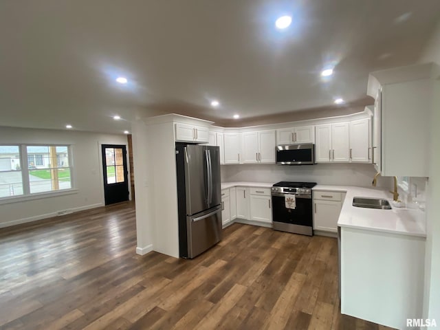 716 W Pauline St, Taylorville, IL 62568 - kitchen with stainless steel appliances, dark wood-style flooring, a sink, white cabinetry, and recessed lighting