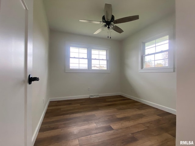 unfurnished room featuring dark hardwood / wood-style floors and ceiling fan