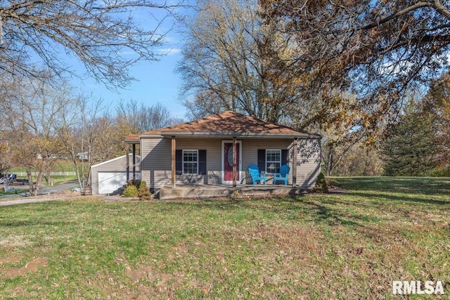 view of front of property with a garage, a porch, and a front yard