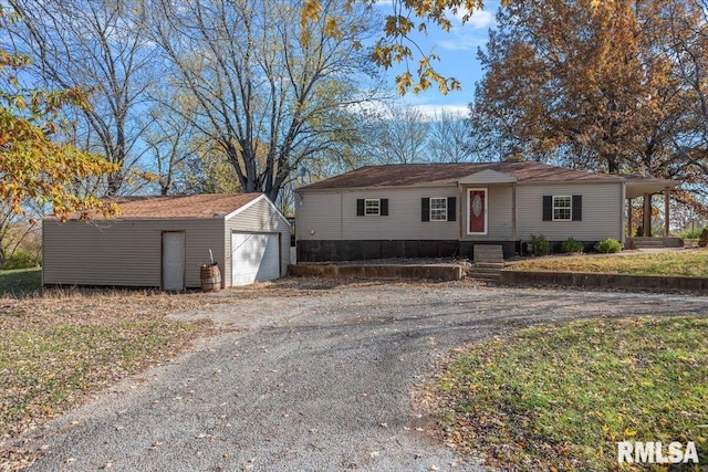 view of front of property featuring an outdoor structure and a garage