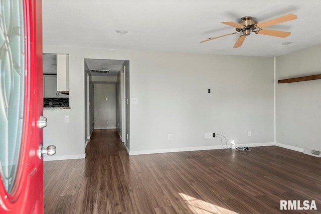 empty room featuring ceiling fan and dark hardwood / wood-style floors