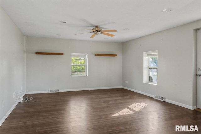 spare room with ceiling fan and dark hardwood / wood-style flooring