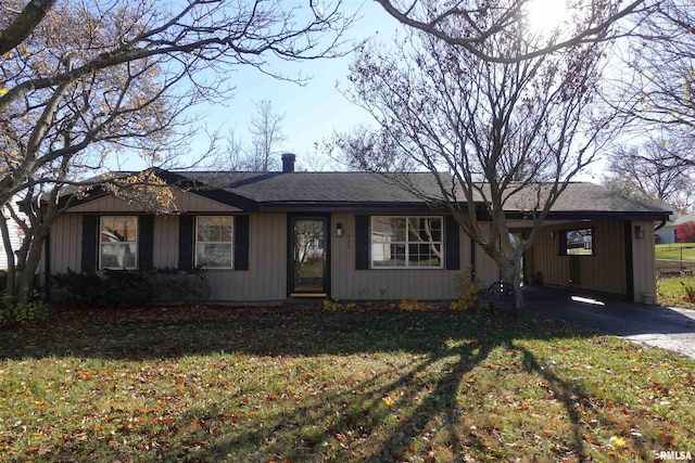 ranch-style home featuring a front yard and a carport