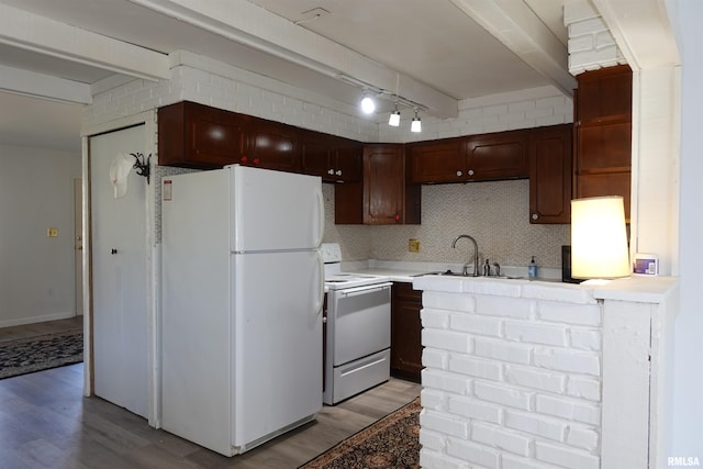 kitchen featuring white appliances, light hardwood / wood-style floors, track lighting, and sink