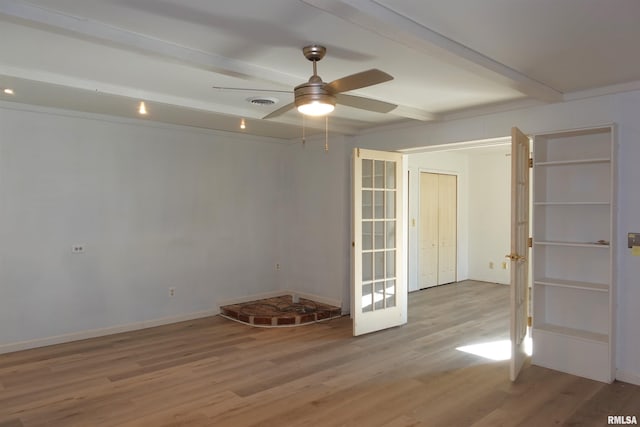 unfurnished room featuring beamed ceiling, ceiling fan, french doors, and light hardwood / wood-style flooring