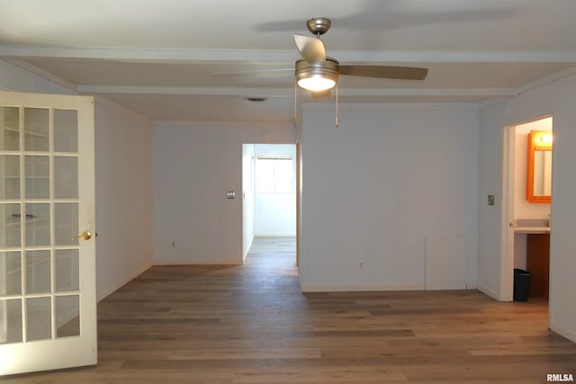 empty room featuring hardwood / wood-style floors, ceiling fan, and beam ceiling