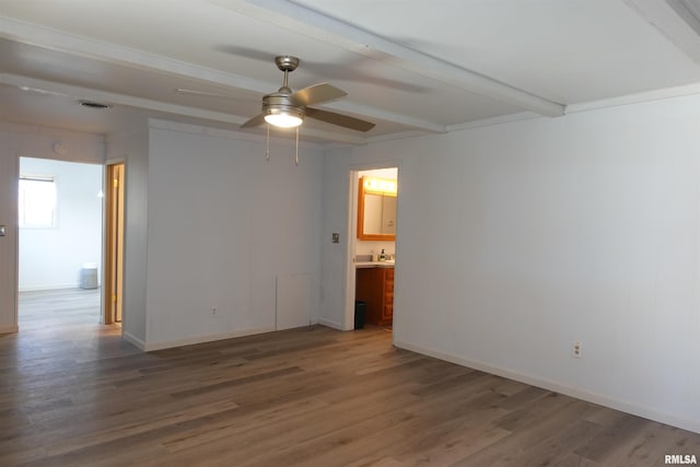 spare room with beamed ceiling, ceiling fan, and hardwood / wood-style flooring