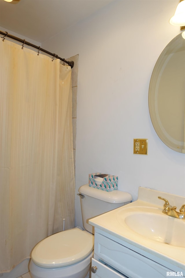 bathroom with vanity, curtained shower, and toilet