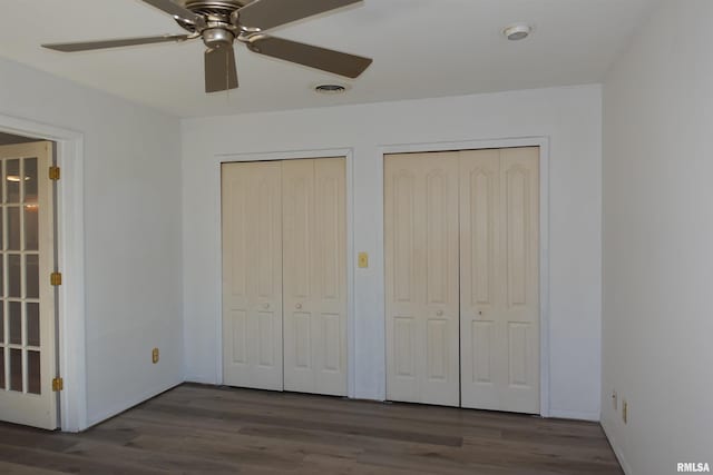 248 W Sanborn St, Galesburg, IL 61401 - unfurnished bedroom with two closets, wood finished floors, and ceiling fan