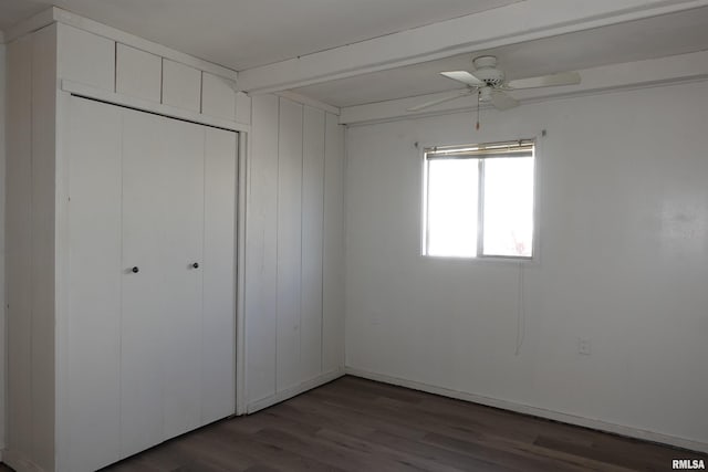 unfurnished bedroom with ceiling fan, dark hardwood / wood-style flooring, and a closet