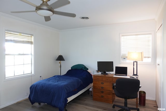 bedroom with ornamental molding, multiple windows, dark wood-type flooring, and ceiling fan