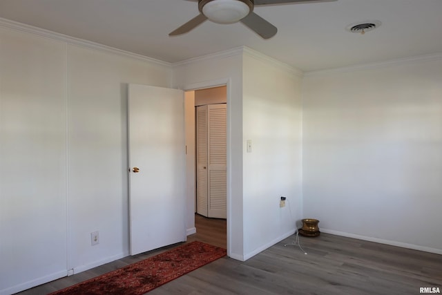 empty room with crown molding, ceiling fan, and wood-type flooring