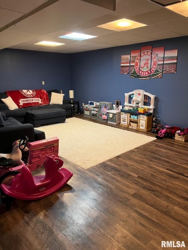 recreation room featuring wood-type flooring and a drop ceiling