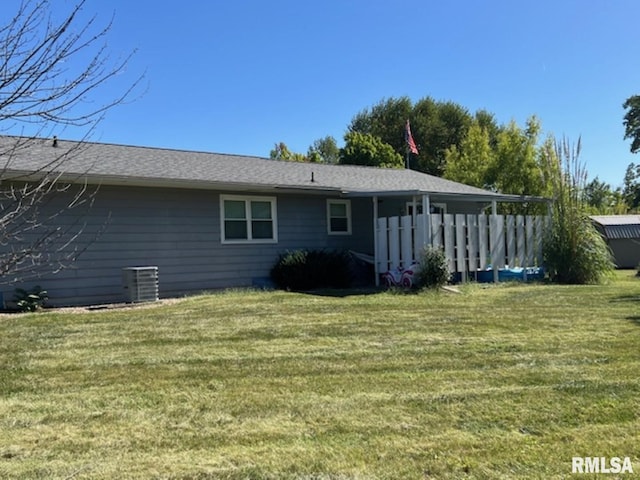 212 N Eastview St, Camp Point, IL 62320 - back of house with central air condition unit and a yard
