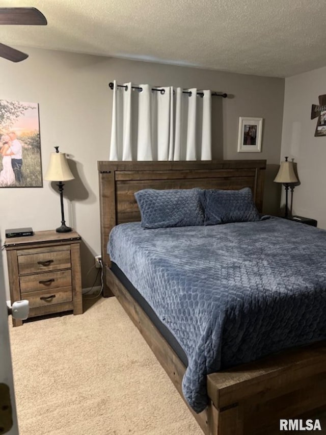 bedroom featuring ceiling fan and a textured ceiling