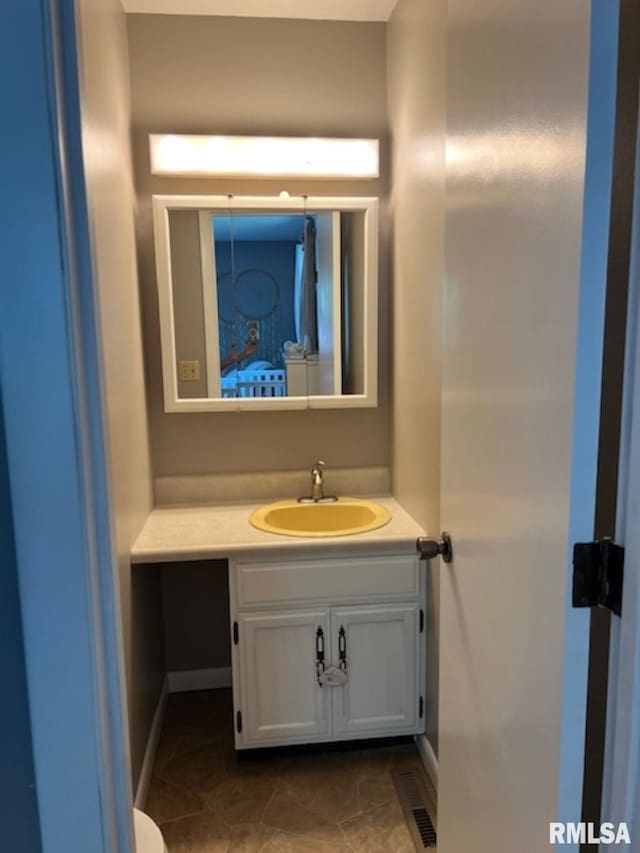 bathroom with tile patterned flooring and vanity