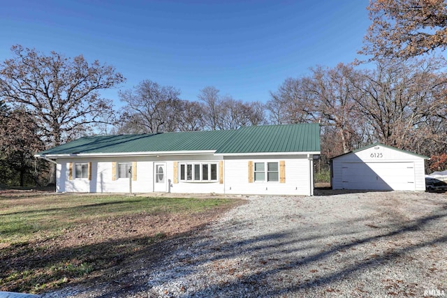 ranch-style home with a front yard, an outdoor structure, and a garage