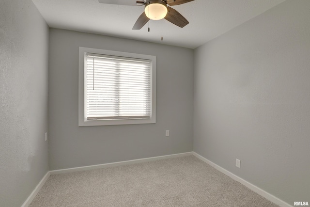 empty room with carpet, baseboards, and a ceiling fan