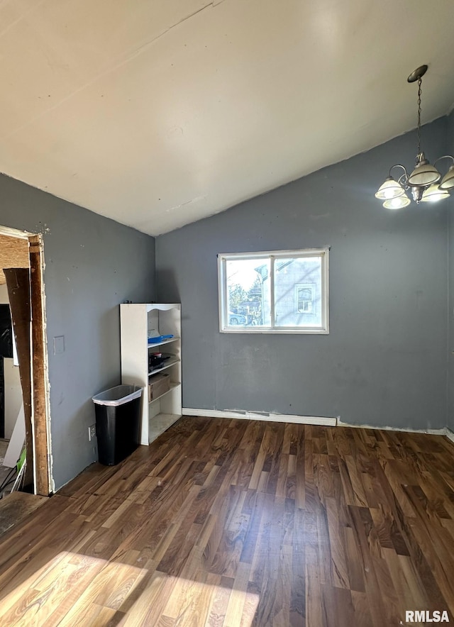 unfurnished living room featuring a chandelier, dark hardwood / wood-style flooring, and lofted ceiling