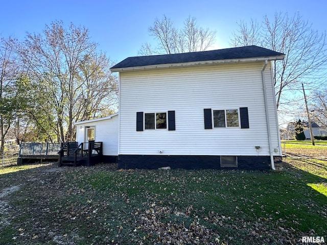 view of property exterior featuring a yard and a wooden deck