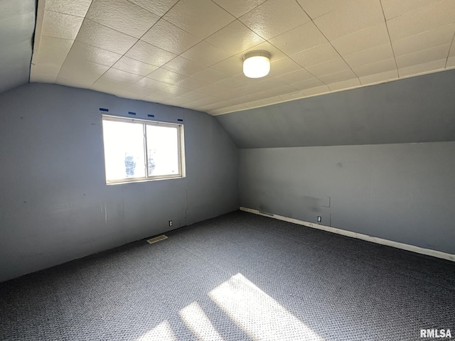 bonus room with carpet flooring and lofted ceiling