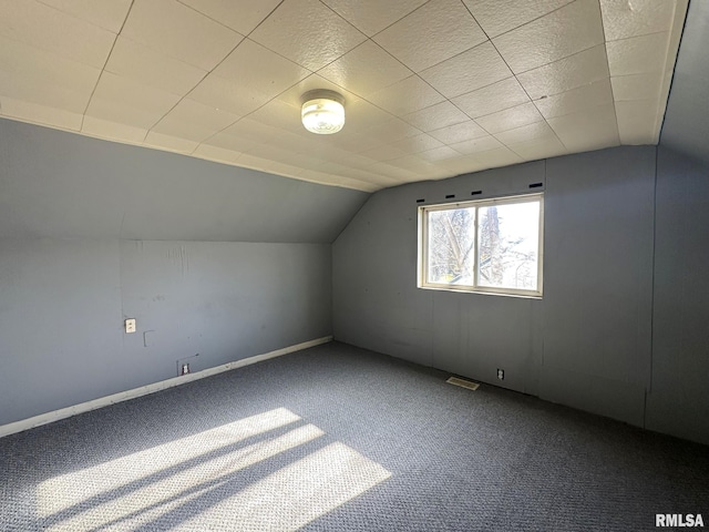 bonus room with lofted ceiling and carpet floors