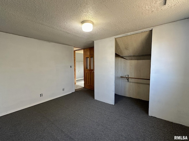 508 S Main St, Abingdon, IL 61410 - unfurnished bedroom featuring a textured ceiling, dark colored carpet, and a closet